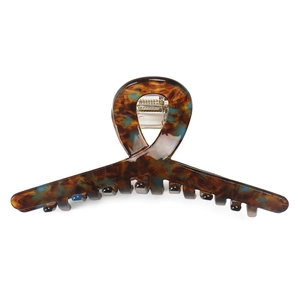 Detail of tortoise shell acetate claw clip with amber texture and silver spring