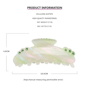 Detail view of large acetate hair claw clip showing size dimensions and green rhinestone inlay