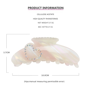 Detail view of cellulose acetate hair claw with heart rhinestones and size dimensions
