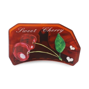 Detail view of acetate cherry hair claw clip in amber with Sweet Cherry print