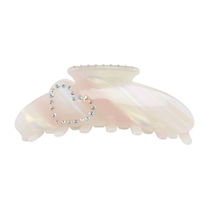 Detail of large iridescent acetate hair claw clip with colorful rhinestone heart