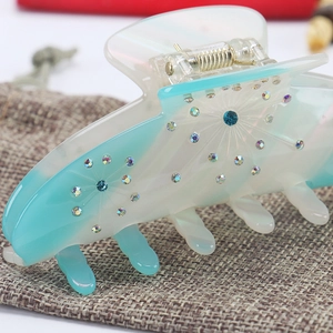 Large acetate hair claw clip with blue gradient and colorful rhinestone floral pattern