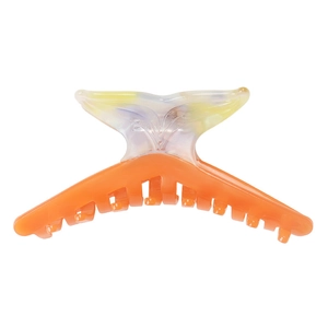 Detail of orange jelly shark clip with marble texture fishtail design and acetate finish