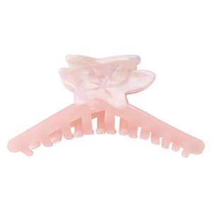Detail of flower and butterfly shaped jelly pink acetate hair claw clip with pearly texture