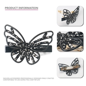Macro detail of elegant black butterfly hair claw with intricate rhinestone inlay and metal clip
