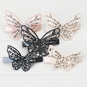Close-up of five butterfly hair clips with hollow design and sparkling rhinestones