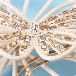 Macro shot of butterfly hair clip with champagne crystals and ivory base detail