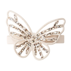 Close-up of butterfly hair clip with champagne rhinestones and cream white base
