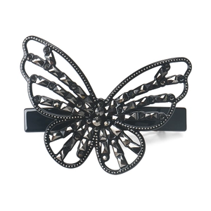 Close-up of black butterfly hair clip with grey sparkling crystals on white background