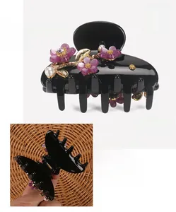 Detail view of acetate flower hair claw clip with purple petals and pearl rhinestones