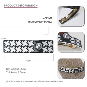 French vintage houndstooth hair clip in acetate with a large pearl and golden spring