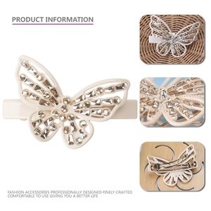 Elegant butterfly hair clip with champagne rhinestones and hollow design on white base