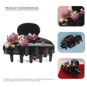 Elegant black acetate flower hair claw clip with purple petals and pearl accents