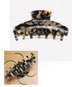 Detail of a large acetate leopard hair claw clip with marble texture measuring 11x4.5cm