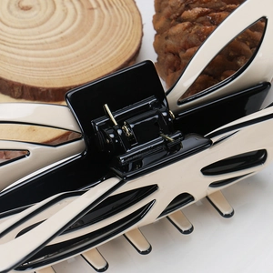 Macro detail of the metal spring hinge on an oversized acetate hair claw clip