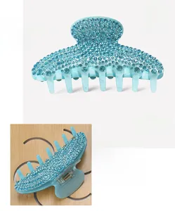 Detailed macro view of light blue acrylic hair claw with sparkling rhinestones 10.8cm size