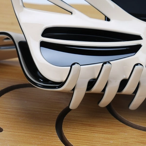 Macro view of two-tone acetate hair claw clip showing polished cream and black layered finish