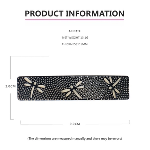 Detail view of acetate barrette showing navy hollow mesh and beige dragonfly motifs
