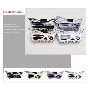 Oversized acetate butterfly hair claw clip with hollow wing design in marble patterns