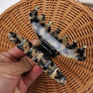 Detailed view of leopard tortoise hair claw clip with strong spring and resin teeth
