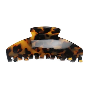 Close-up of vintage leopard print hair claw clip with glossy tortoiseshell texture finish