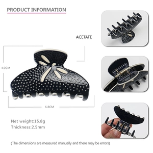 Detailed view of acetate hair claw dimensions 6.8cm with blue polka dot dragonfly design