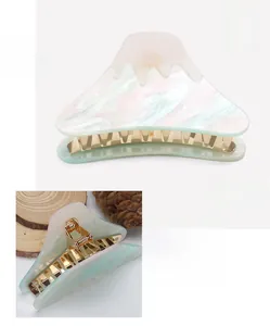 Macro detail of Mount Fuji acrylic hair claw with marble texture and metal spring