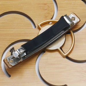 Detail view of heavy-duty hair clip metal spring and black rubber anti-slip sleeve