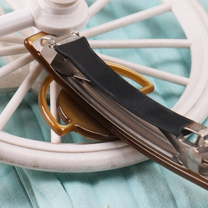Detailed close-up of the vintage amber hair clip with durable non-slip metal spring mechanism