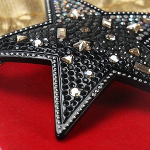 Macro de la pince à cheveux étoile en acétate noire avec cristaux et billes argent
