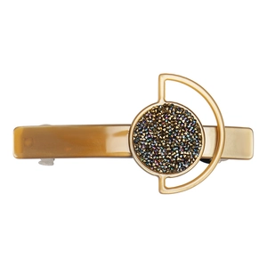 Detailed macro view of vintage hair clip with amber brown tones and inlaid rhinestones