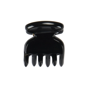 Close-up of a small black glossy acetate hair claw clip with smooth teeth on white background