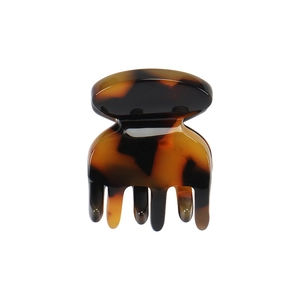 Detailed view of the small tortoiseshell hair claw clip with a polished finish