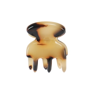Macro shot of mini tortoise shell acetate hair claw clip with glossy finish and metal spring