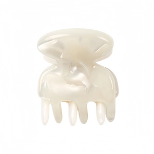 Close-up of pearl white acetate mini hair claw clip with a glossy iridescent finish