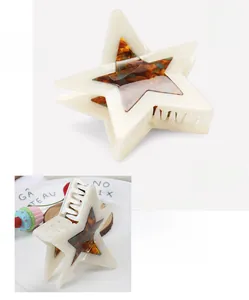 Detailed view of cream-colored star hair claw made of acetate with tortoiseshell pattern