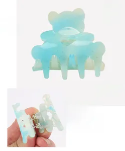 Mini acrylic bear hair claw in blue glitter finish with heart cutout and dimensions