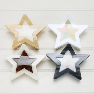 Detail view of double-layer hollow star hair claws in various acetate patterns