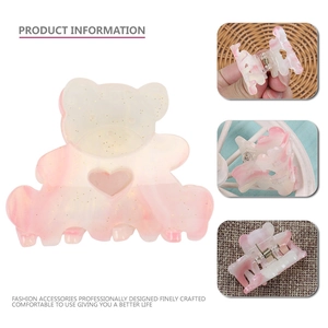 Detail view of mini bear hair claw clip with pink gradient marble and glitter finish