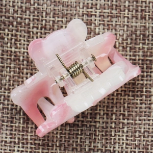 Detailed view of pink marble bear hair claw clip with a strong metal spring