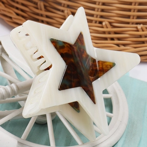 Detailed macro view of the star-shaped acetate hair claw clip with marble texture