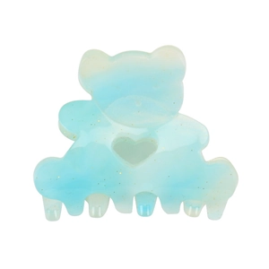 Close-up of a blue bear-shaped acrylic hair claw clip with golden glitter details