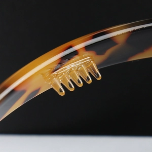 Detail of tortoise shell headband with non-slip teeth for secure grip and comfort