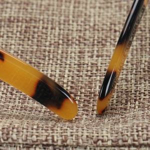 Macro detail of tortoiseshell acetate eyeglass temples with polished finish