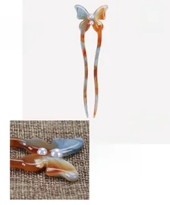 Detail view of acetate butterfly hair pin with pearls measuring 12x3.6cm and weighing 6g