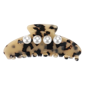 Detail view of acetate tortoise shell hair claw clip with four elegant white pearls