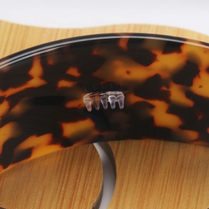 Macro detail of tortoiseshell acetate headband showing anti-slip teeth and texture