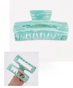 Detail view of 14cm large acetate hair claw clip showing size and marble texture