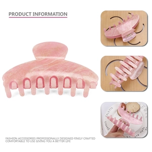 Detail view of pink marble acrylic hair claw clip with golden glitter and sturdy metal spring