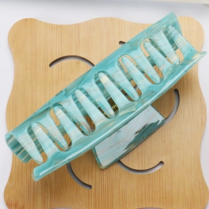 Macro detail of large rectangular marble textured Tiffany blue hair claw clip